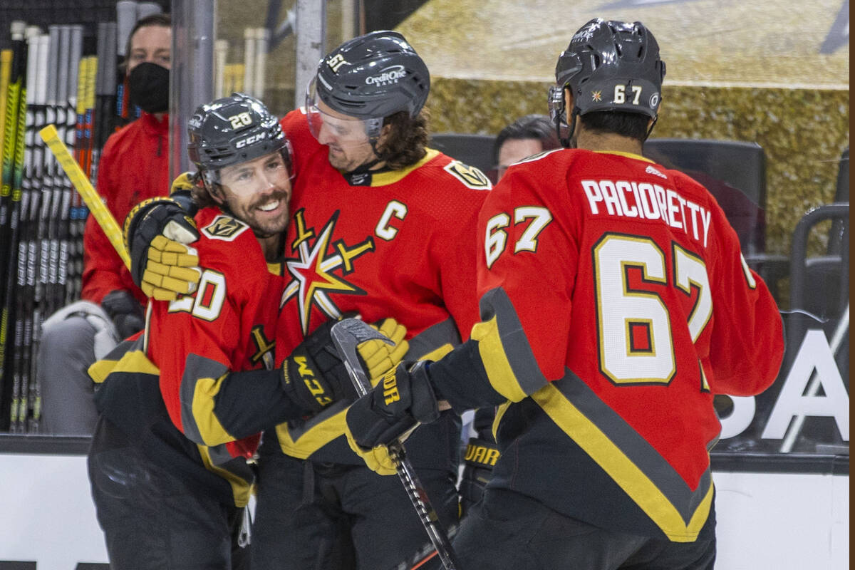 Golden Knights center Chandler Stephenson (20) is congratulated on a score by right wing Mark S ...