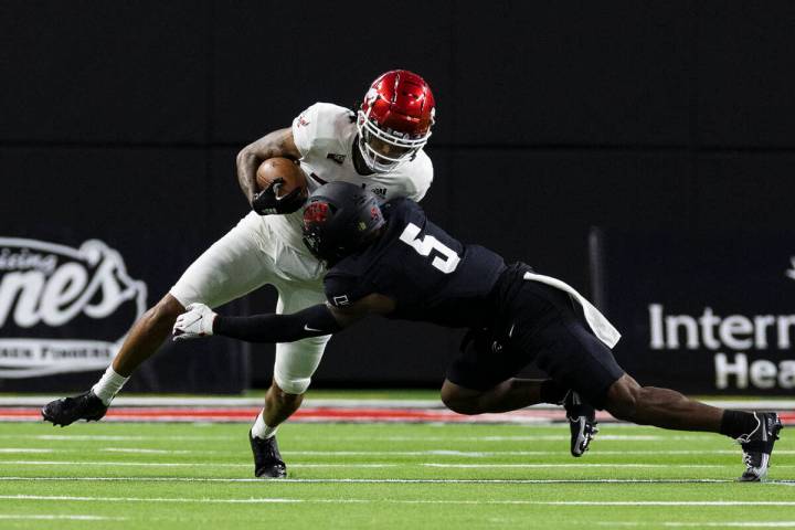 UNLV Rebels defensive back Phillip Hill (5) tackles Eastern Washington UniversityÕs wide r ...