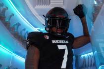 UNLV defensive end and Bishop Gorman grad Adam Plant Jr. shows off UNLV's new black uniforms at ...