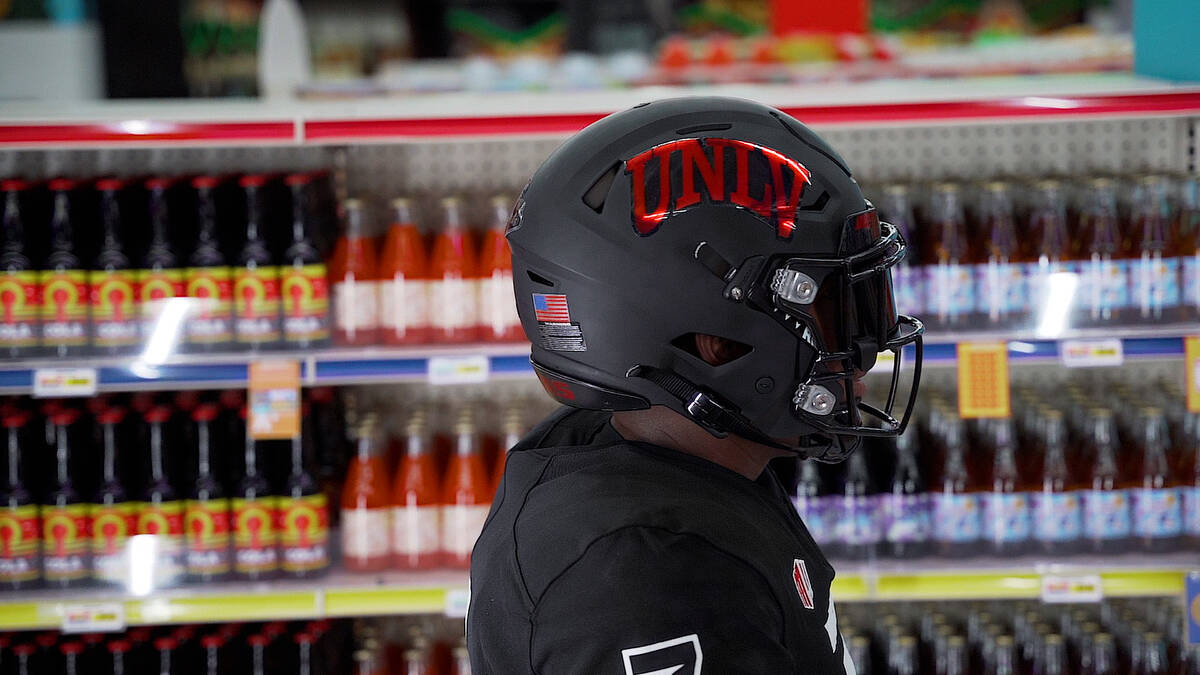 UNLV defensive end and Bishop Gorman grad Adam Plant Jr. shows off UNLV's new black uniforms at ...