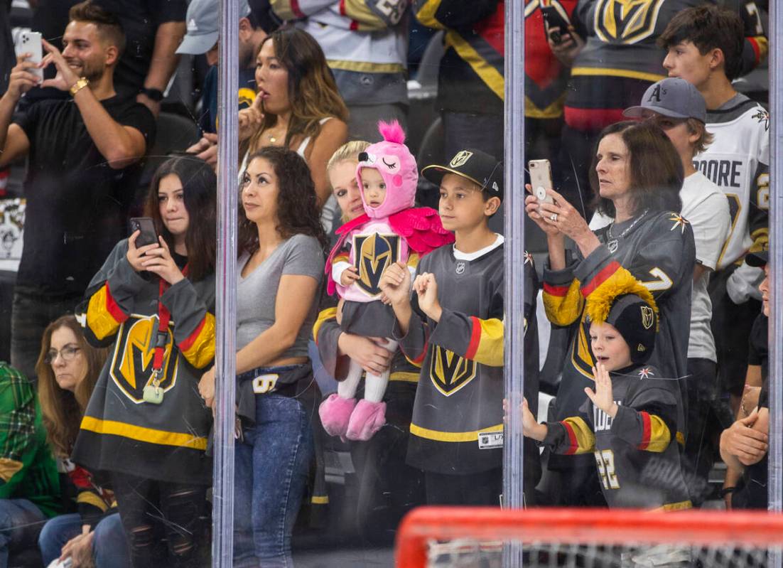 Golden Knights fans get pumped look to the players as they take the ice during warm ups before ...