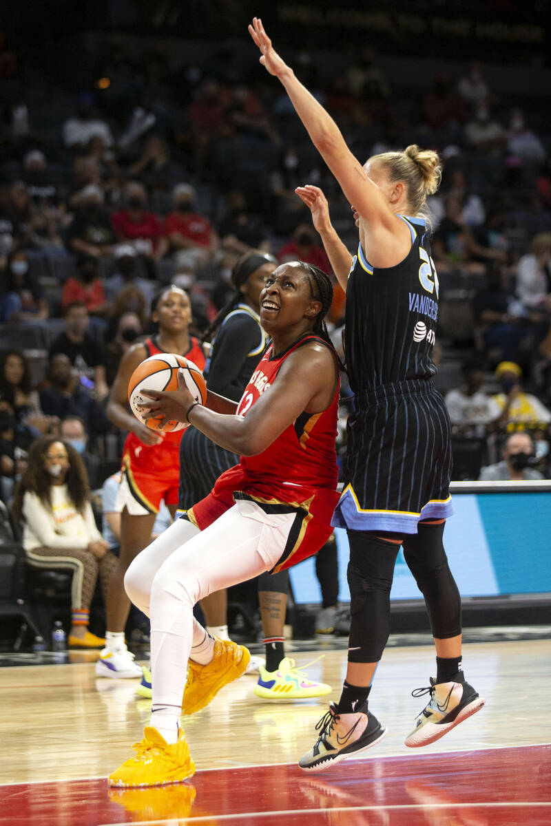 Las Vegas Aces guard Chelsea Gray (12) goes up for a shot guarded by Chicago Sky guard Courtney ...