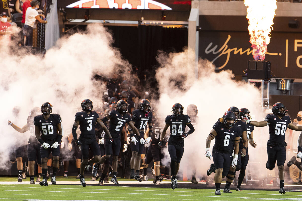 UNLV Rebels players take the field to face Eastern Washington University during their NCAA foot ...