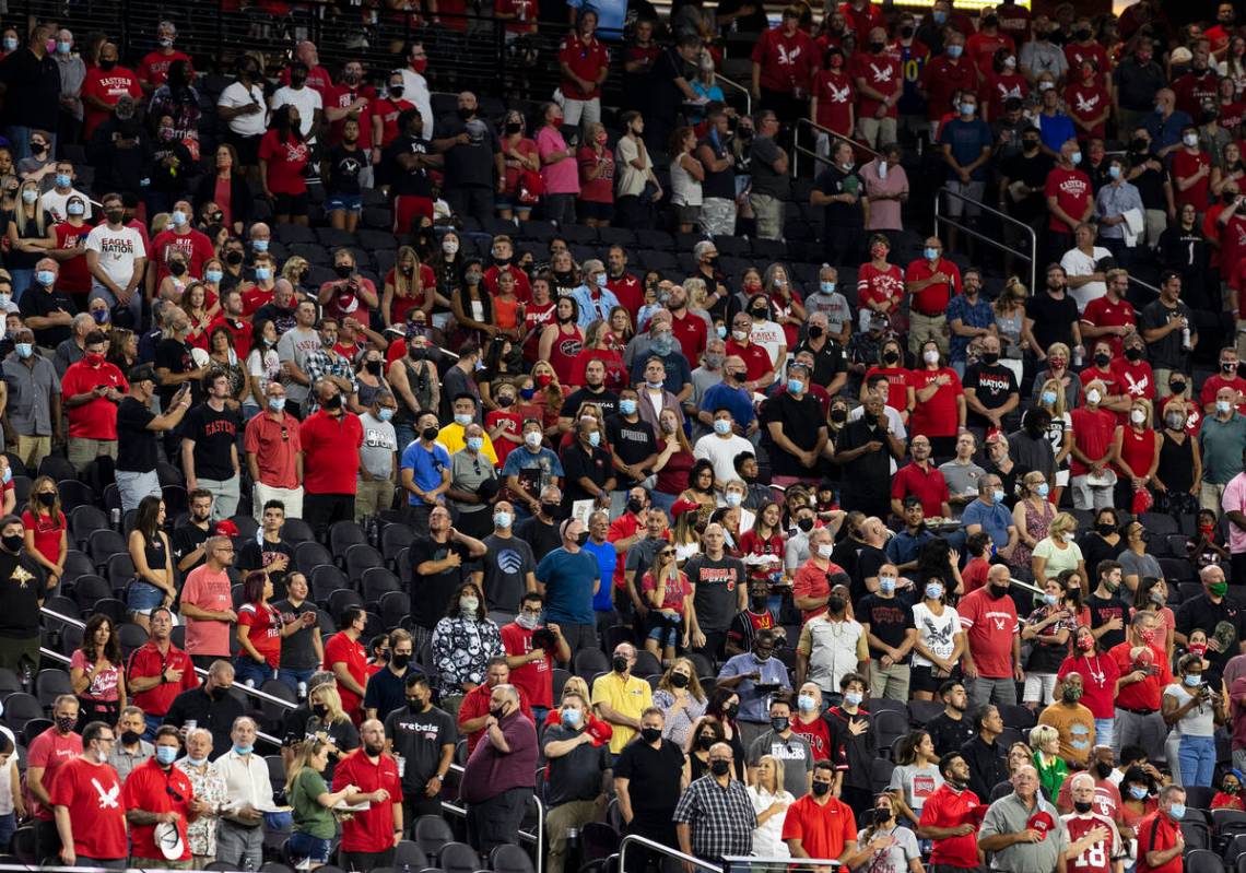 Fans stand during the National Anthem before an NCAA football game between UNLV Rebels and East ...