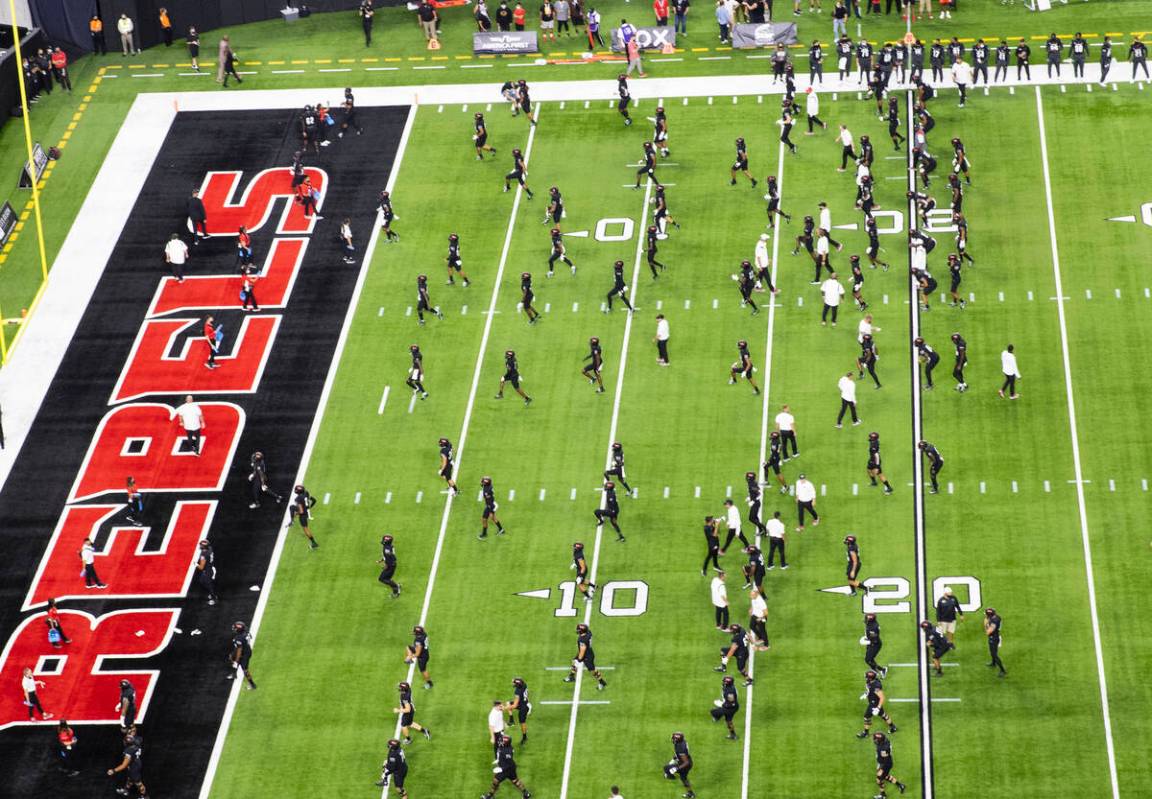 UNLV Rebels players warm up before an NCAA football game against Eastern Washington University ...