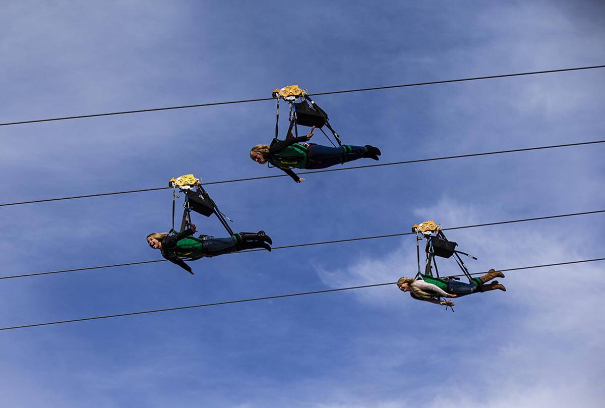 People react as they take off on the Slotzilla zip line over Fremont Street in downtown Las Veg ...