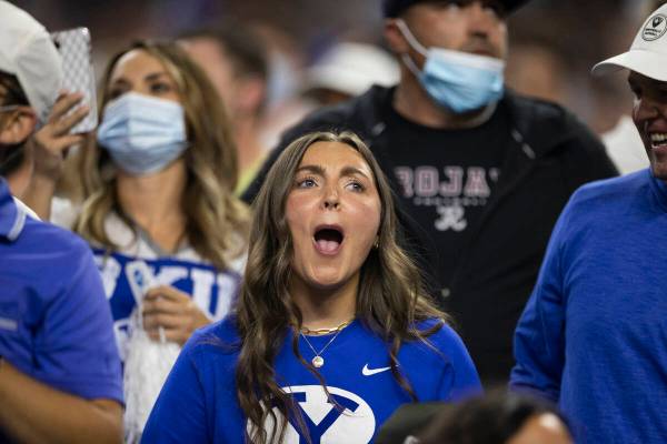 BYU fans cheer for the Cougars in the first quarter during a college football game against the ...