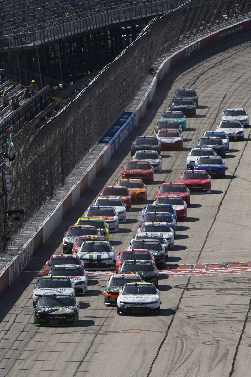 Justin Allgaier, left, and AJ Allmendinger, right, lead as cars are released from the first yel ...