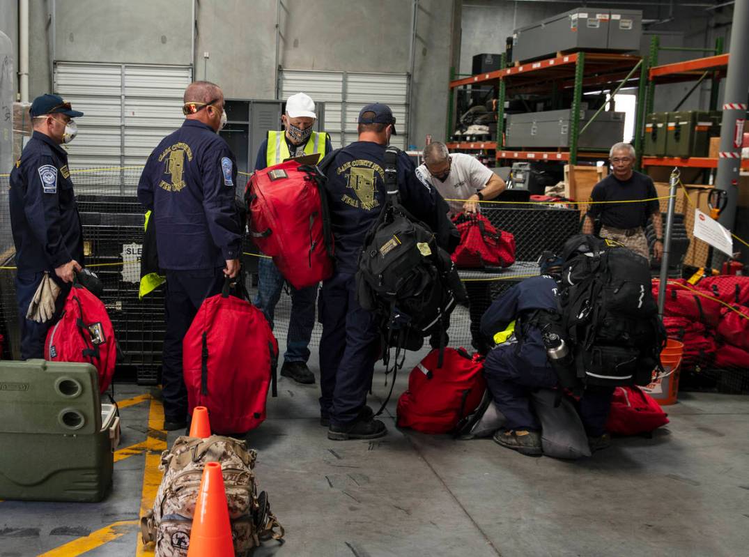 Members of the Nevada Task Force 1 sign in to return their equipments after arriving at Nevada ...