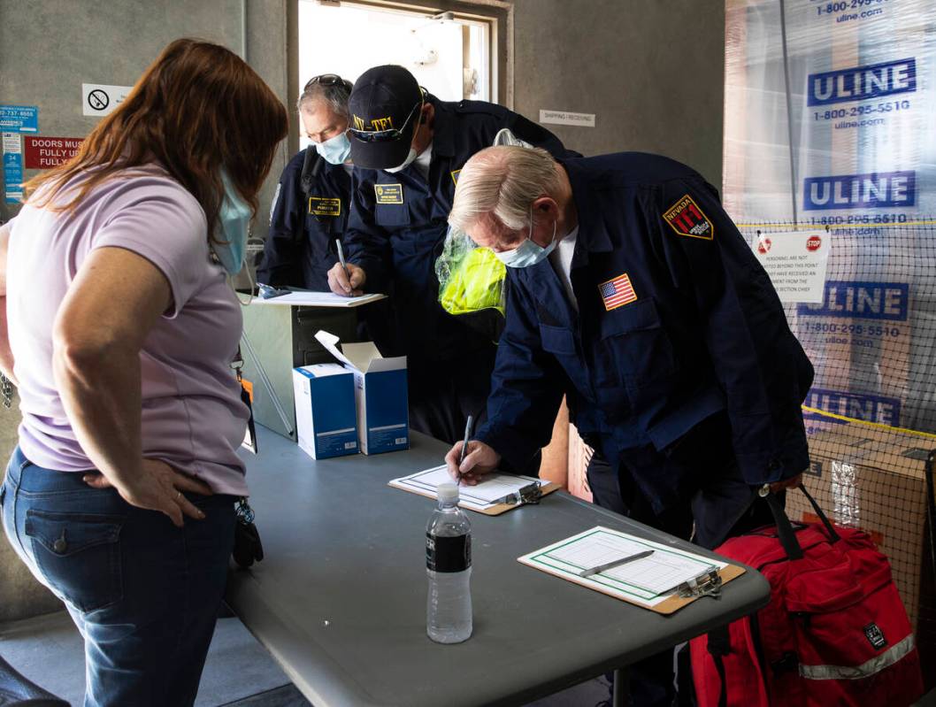 Members of the Nevada Task Force 1 sign in to return their equipments after arriving at Nevada ...