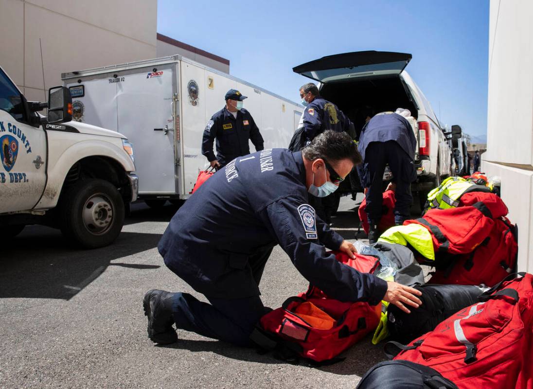 Members of the Nevada Task Force 1, including Tim Gardner, front, unload their equipments after ...