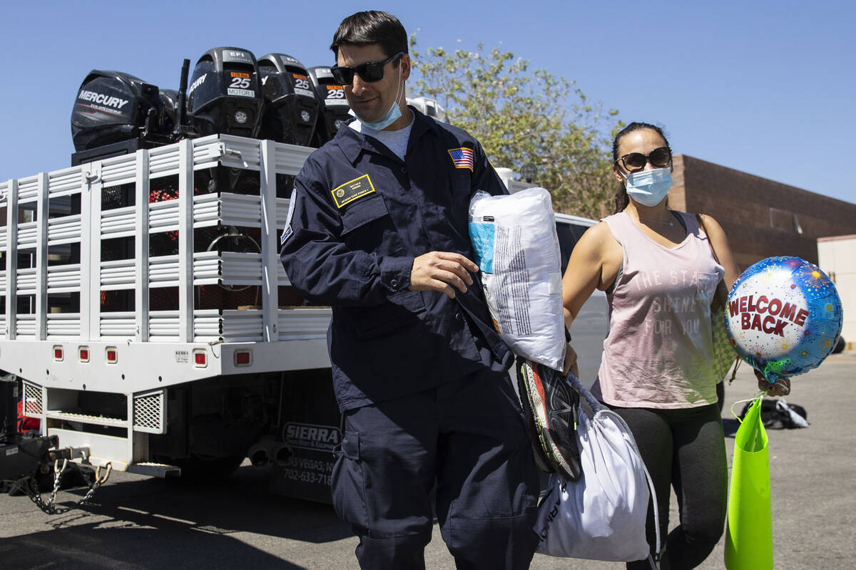 Jessica Gordon welcomes her husband Mathew after he arrived at Nevada Task Force 1 Urban Search ...