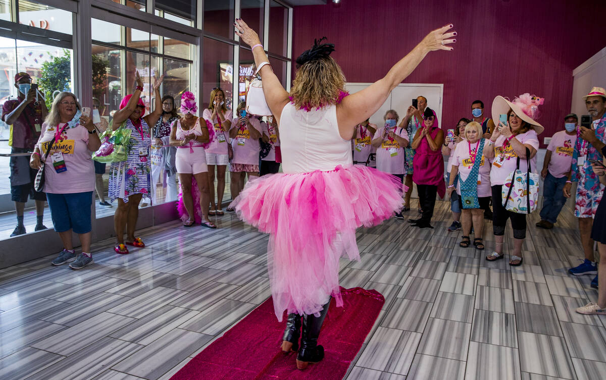 Attendees cheer for another contestant during a costume contest at the 1st Annual Flamingo Fan ...