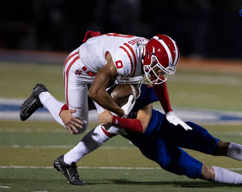 Liberty High safety Ryden-james Dacosin (33) tackles Mater Dei High wide receiver C.J. Williams ...