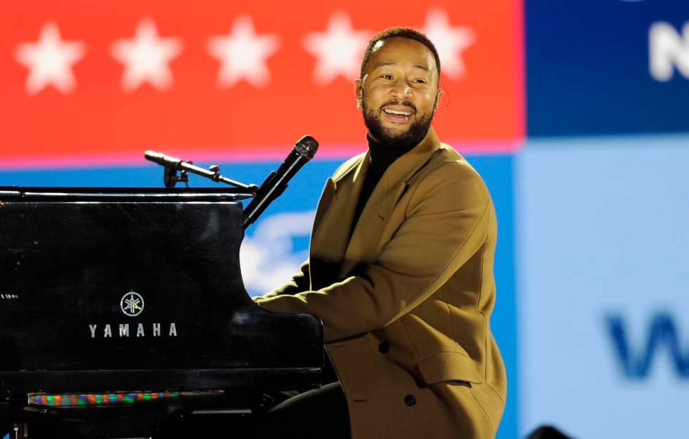 Performer John Legend plays the piano during a Get Out the Vote rally on Monday, Nov. 2, 2020, ...