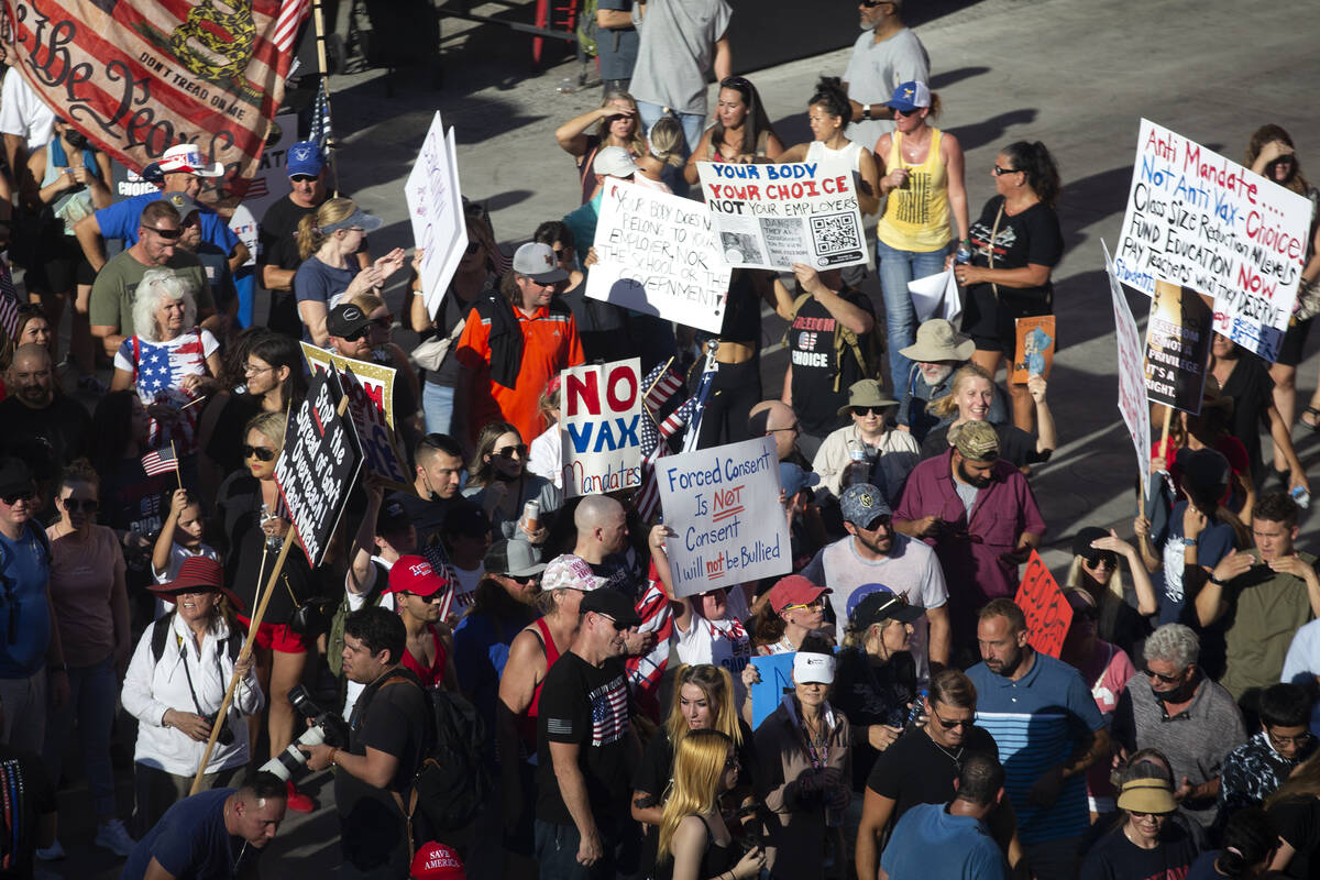 Demonstrators congregate outside Planet Hollywood during an anti-mask, anti-vaccination and fre ...