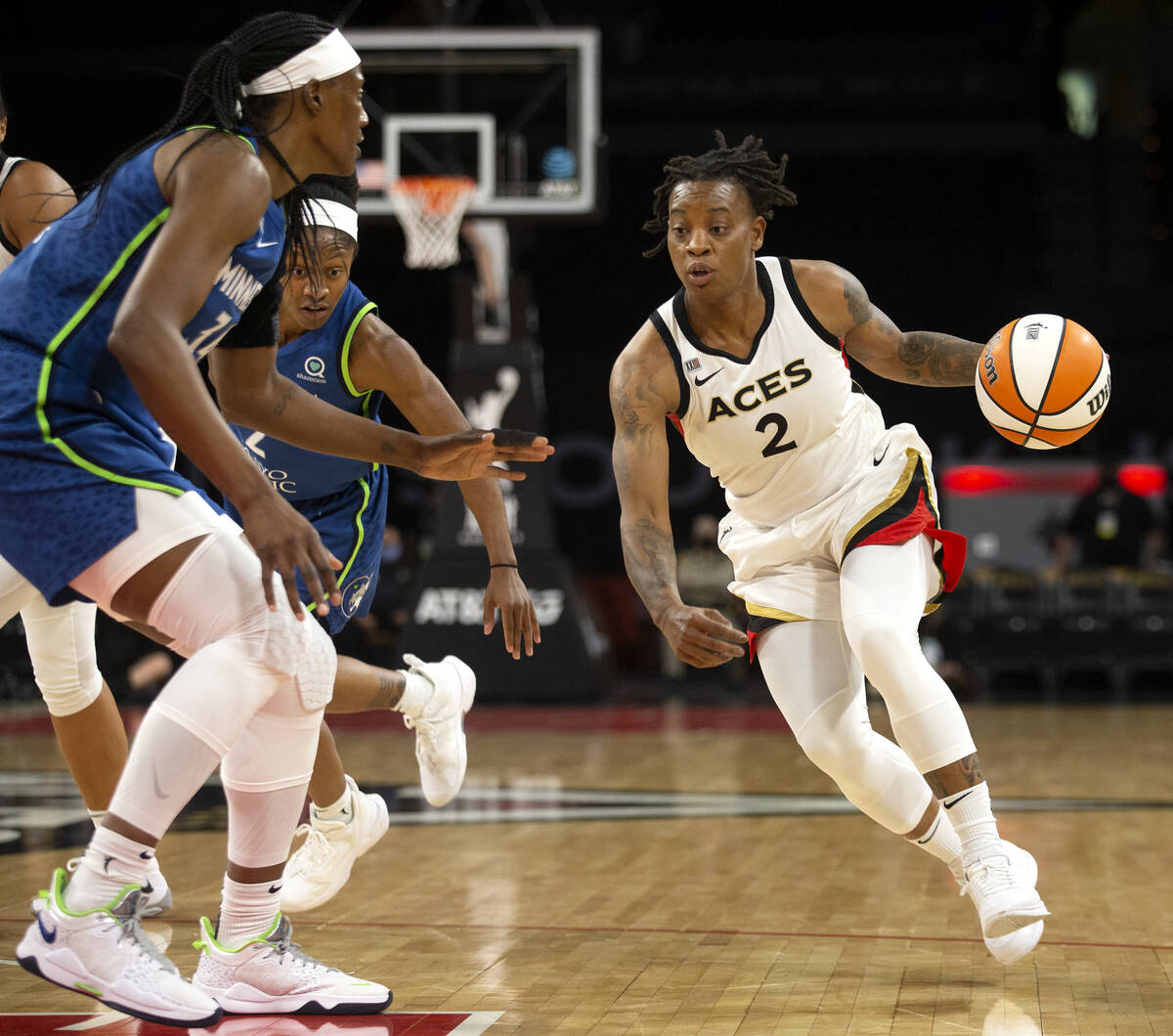 Las Vegas Aces guard Riquna Williams (2) dribbles around Minnesota Lynx center Sylvia Fowles (3 ...