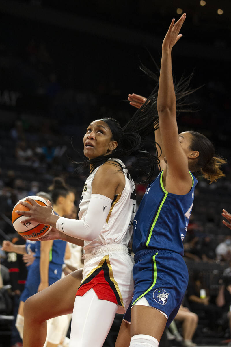 Las Vegas Aces forward A'ja Wilson (22) eyes the hoop guarded by Minnesota Lynx forward Naphees ...