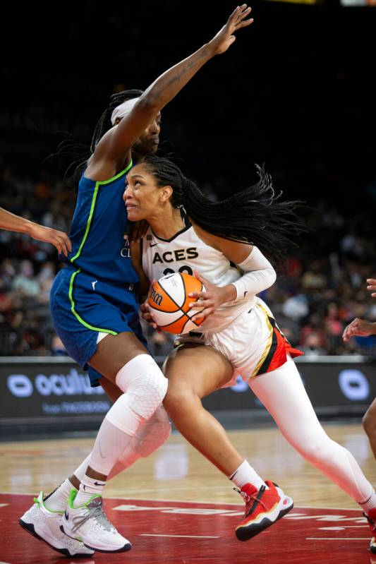 Las Vegas Aces forward A'ja Wilson (22) dribbles around Minnesota Lynx center Sylvia Fowles (34 ...