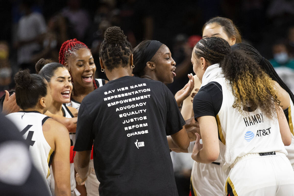 The Las Vegas Aces surround guard Jackie Young (0) after she scored 29 points, her career high, ...