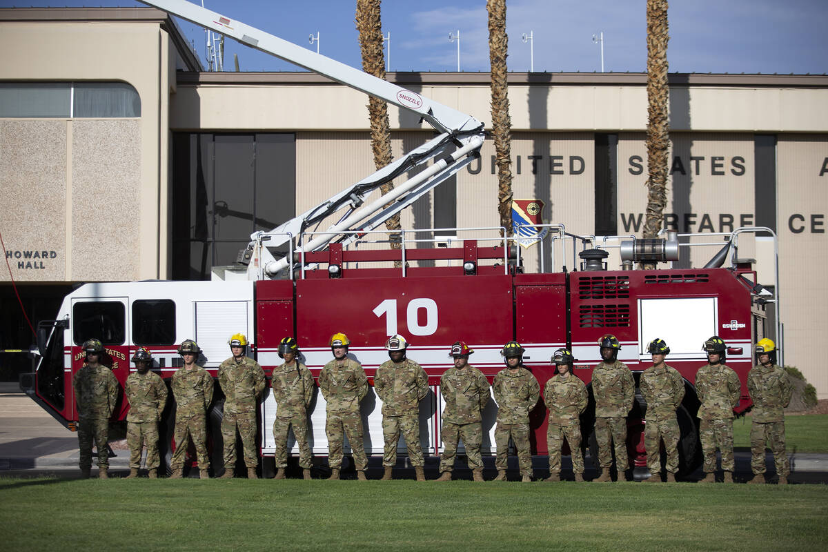 Firefighters stand at attention during the Nellis Fire and Emergency Services 9/11 Memorial Cer ...