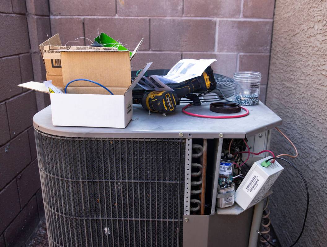 An air conditioner is under repair at Vulcan St on Friday, Sept. 10, 2021, in Henderson. (Bizua ...