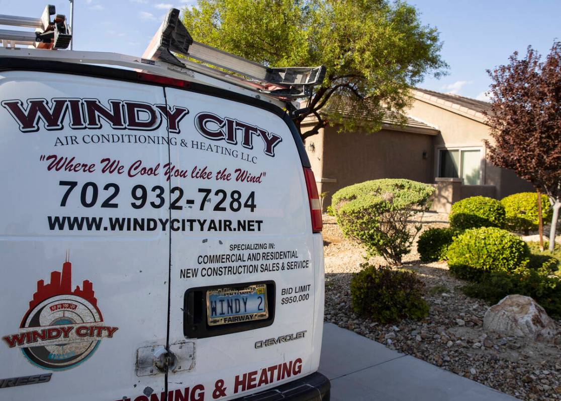 A Windy City Air's van is parked outside a house where Thomas Padron, a technician, repairs an ...