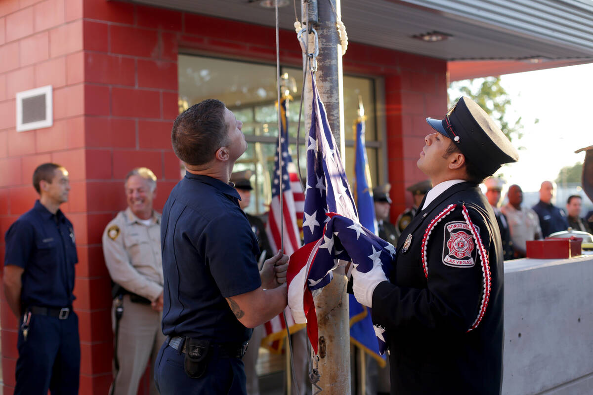 Firefighter Josh Abston, left, and Las Vegas Fire Department Honor Guard member Mario Lueda pre ...