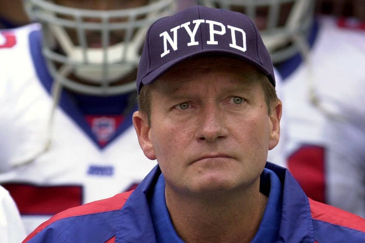 In this Sept. 23, 2001, file photo, New York Giants coach Jim Fassel wears a New York Police D ...
