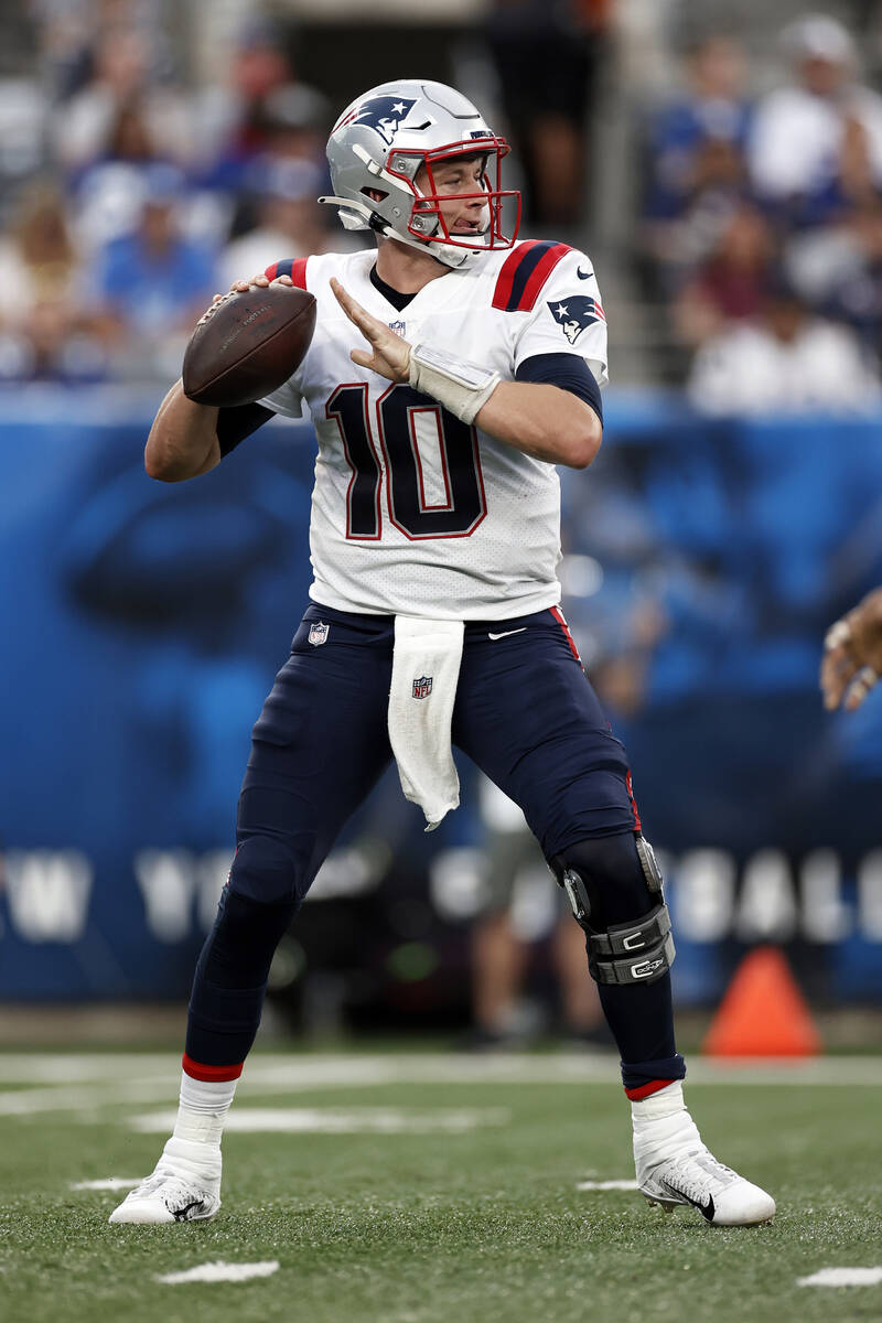 New England Patriots quarterback Mac Jones (10) in action against the New York Giants during an ...