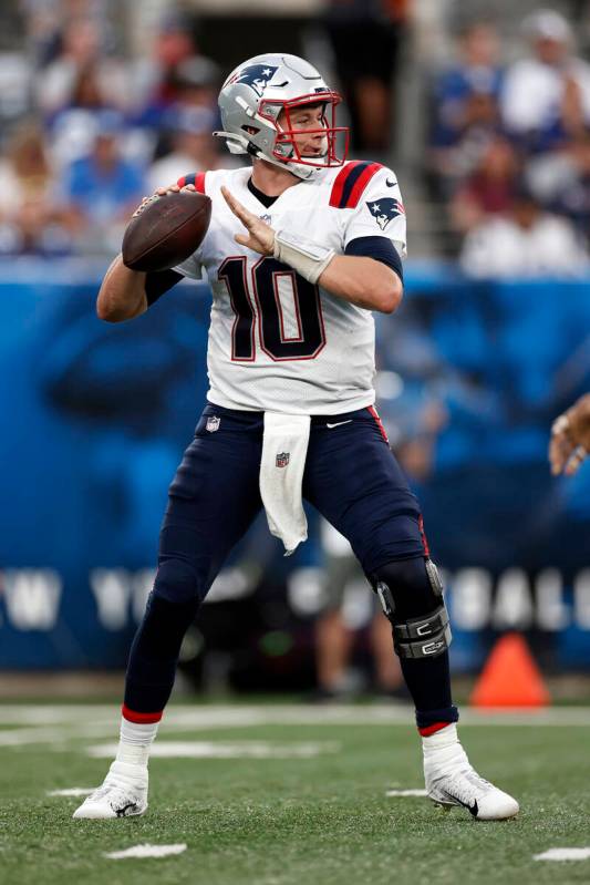 New England Patriots quarterback Mac Jones (10) in action against the New York Giants during an ...