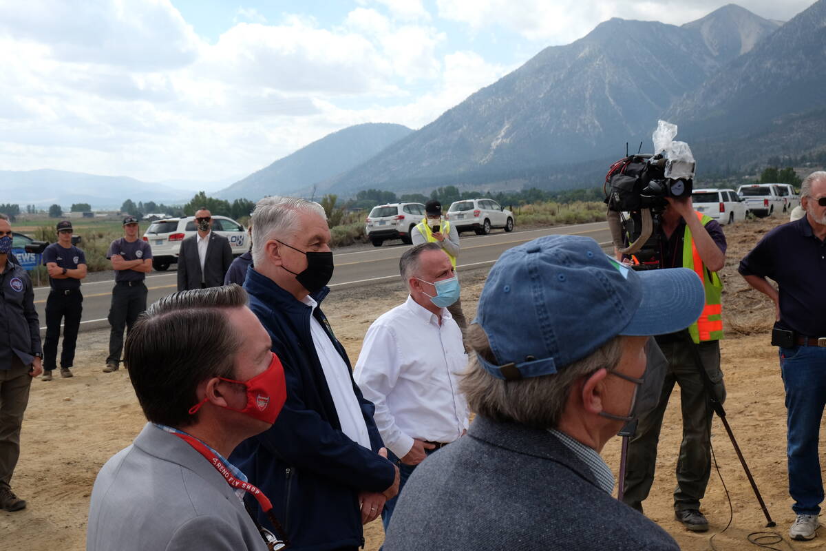 Gov. Steve Sisolak and State Sen. Chris Brooks, D-Las Vegas, listen to a briefing on fire conta ...