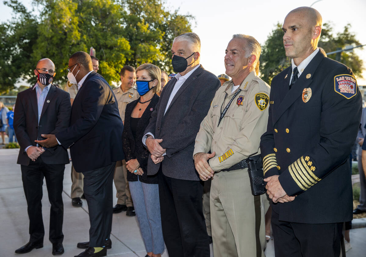 Officials and guests stand, Saturday, Sept. 11, 2021, at Fire Station Five in Las Vegas, during ...