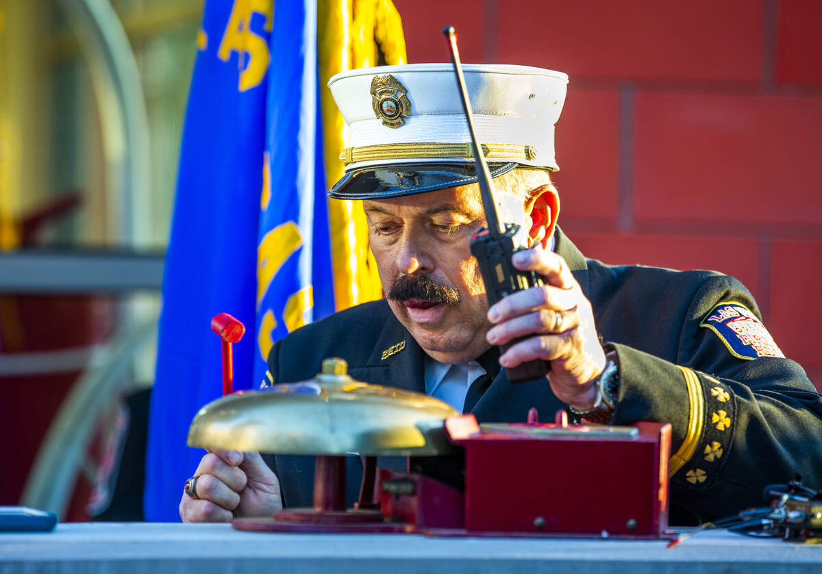 Las Vegas Fire Public Education and Information Officer Tim Szymanski strikes the bell, Saturd ...