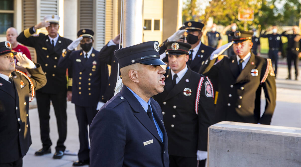 Retired New York City firefighter Frank Pizarro sings the national anthem, Saturday, Sept. 11, ...