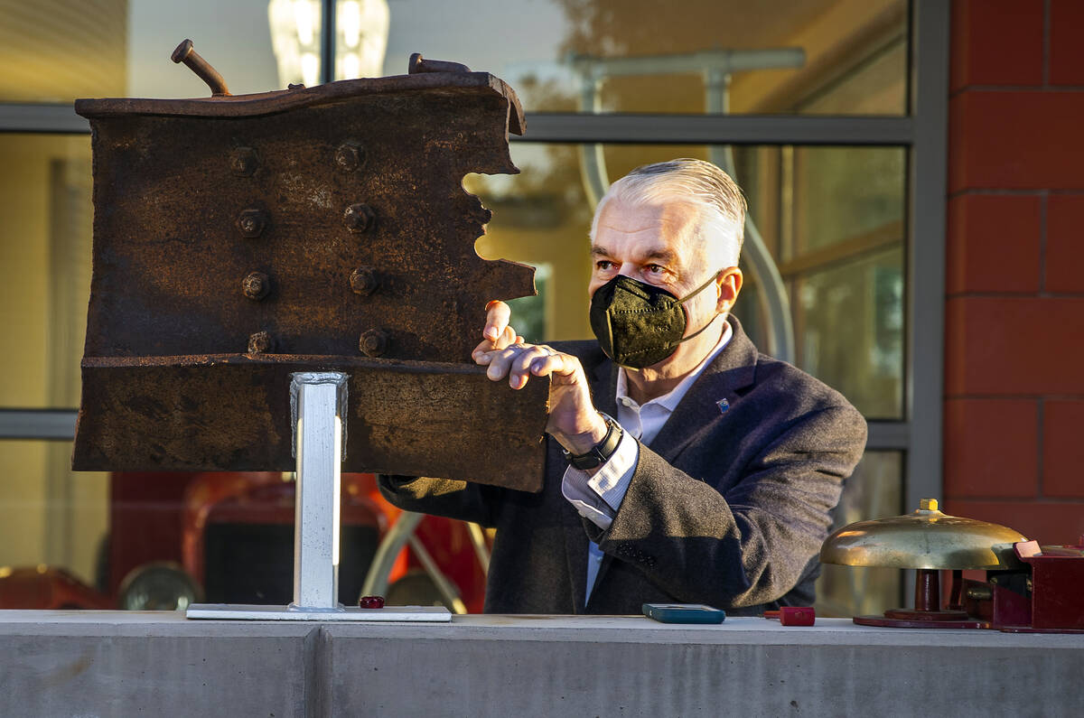 Nevada Gov. Steve Sisolak touches a piece of World Trade Tower steel on display, Saturday, Sept ...