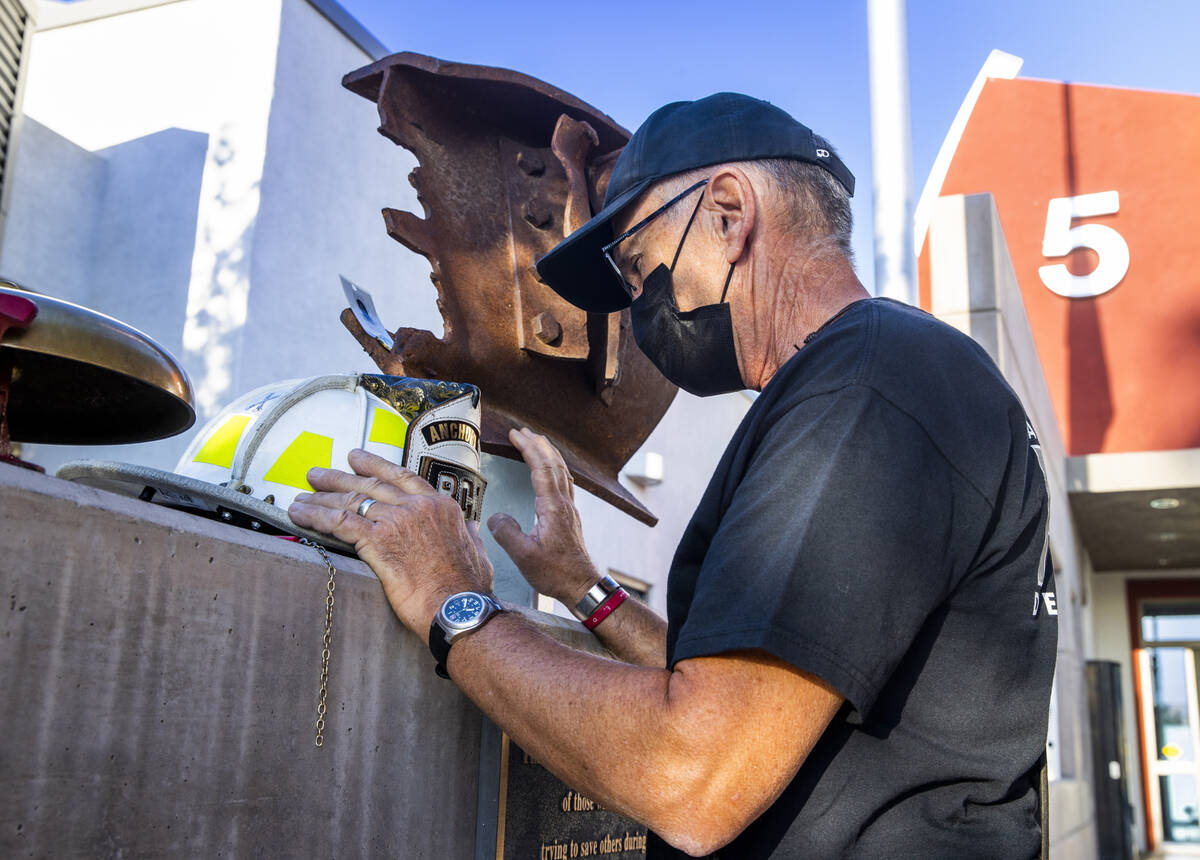 From former Anchorage firefighter John Adamson of St. George, Utah, takes a personal moment at ...