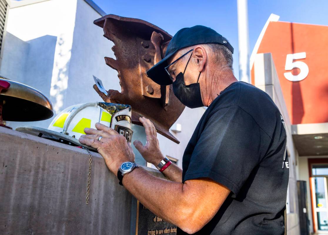 From former Anchorage firefighter John Adamson of St. George, Utah, takes a personal moment at ...