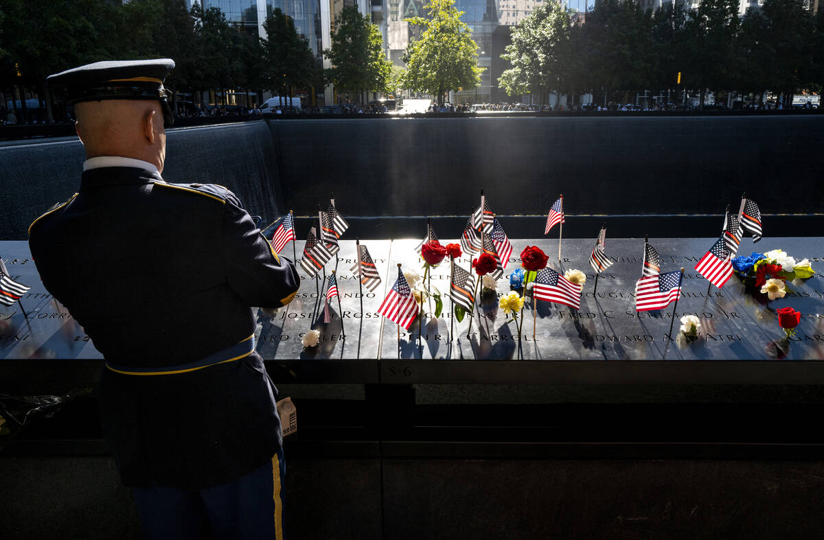 Flags and flowers adorn the names of the victims of the attacks of Sept. 11, 2001, at the Natio ...