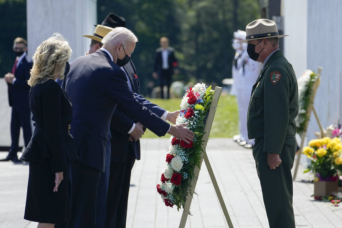 President Joe Biden and first lady Jill Biden lay a wreath at the Wall of Names during a visit ...