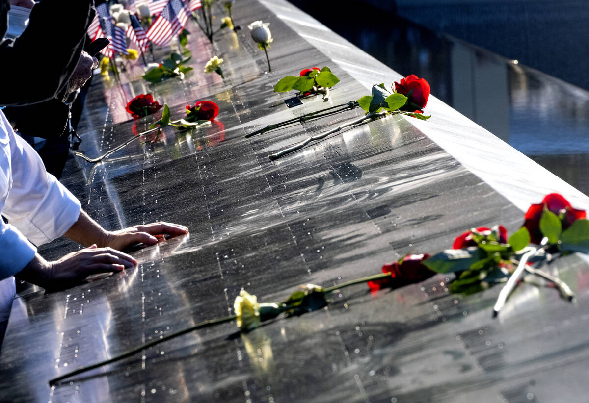 Flowers adorn the names of people who were killed during the attacks on the World Trade Center ...