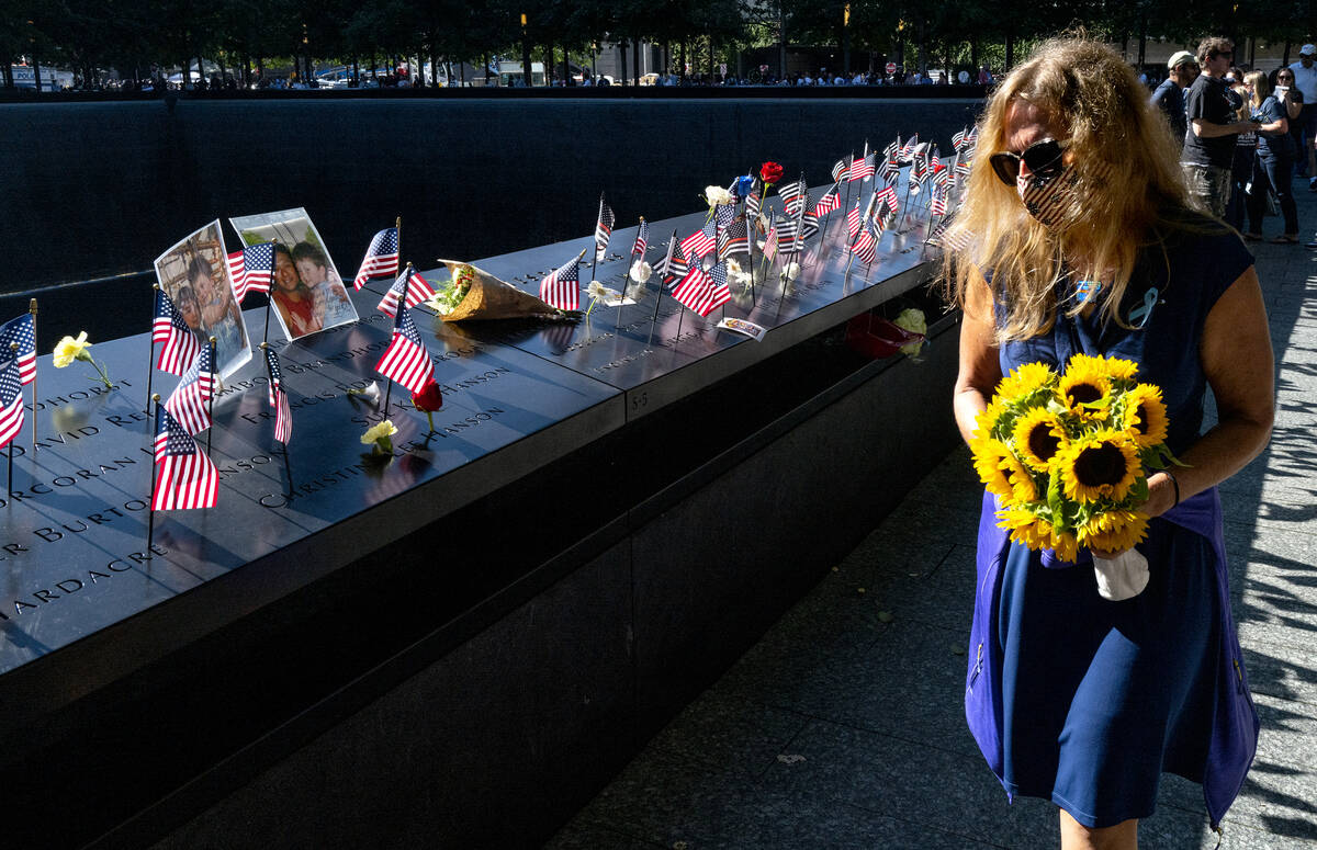Flags adorn the inscribed names of the victims of Sept. 11, 2001, at the National September 11 ...