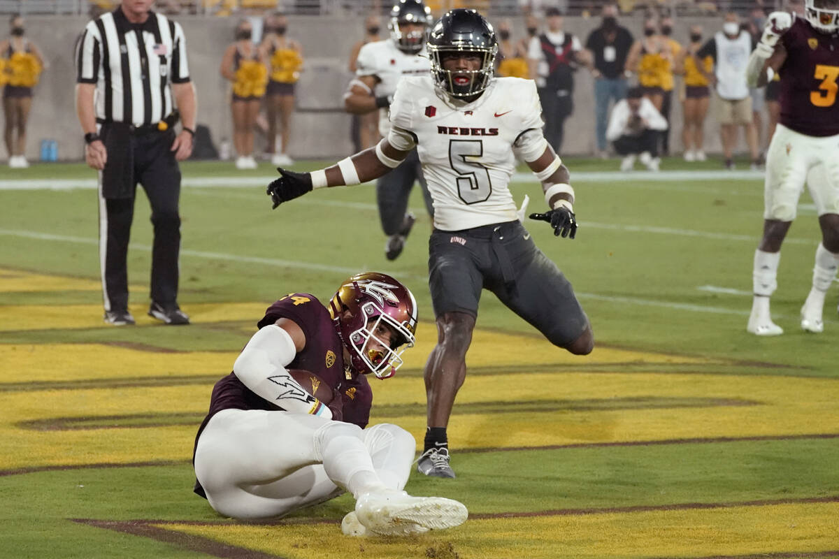 Arizona State wide receiver Johnny Wilson (14) pulls in a touchdown as UNLV defensive back Phil ...