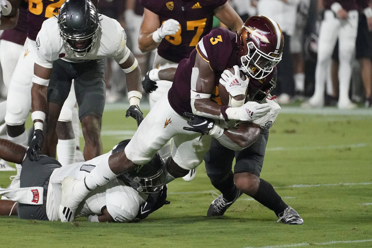 Arizona State running back Rachaad White (3) is hit by UNLV defensive back Bryce Jackson, right ...
