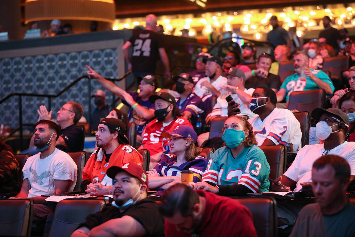 Guests watch the screens for the first week of the NFL season at the Sportsbook at Circa in Las ...