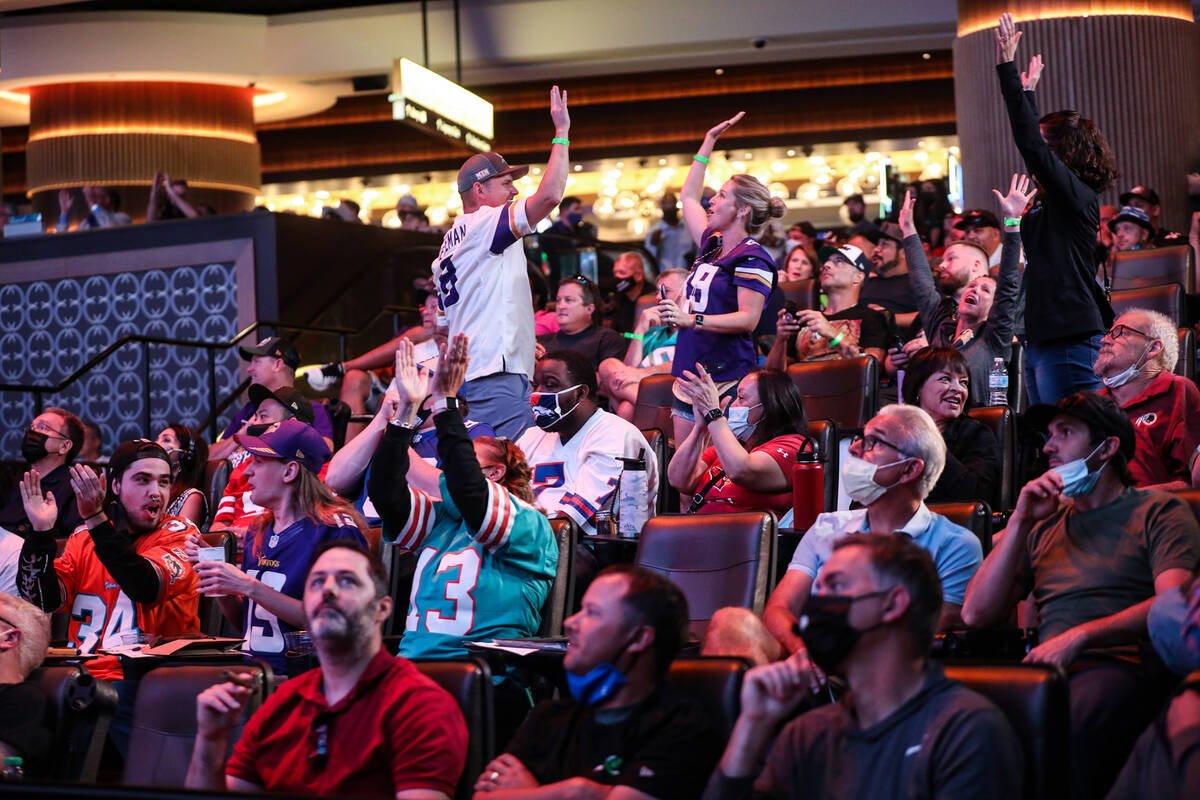 Guests react to a play while watching the Pittsburgh Steelers against the Buffalo Bills at the ...