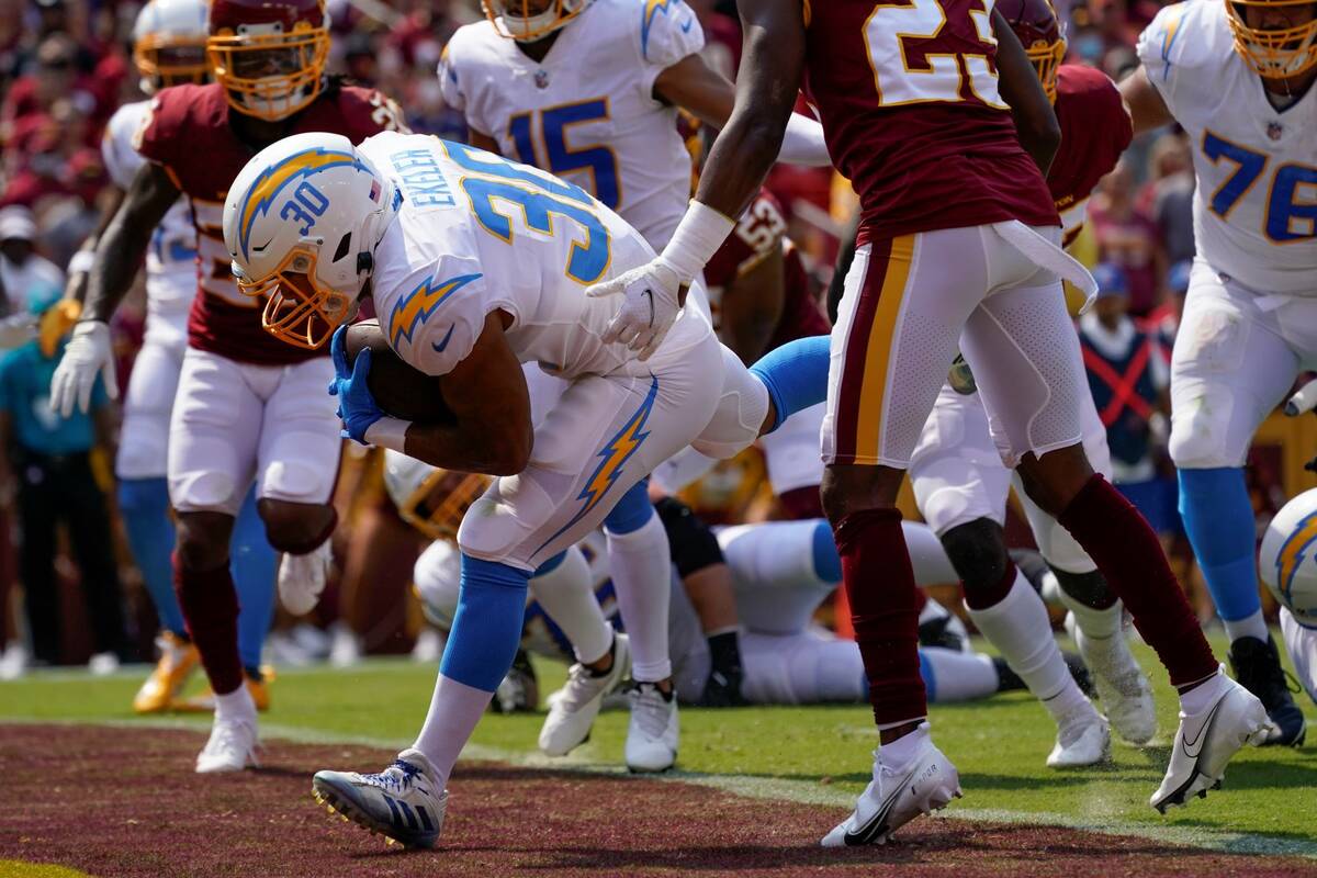 Los Angeles Chargers running back Austin Ekeler (30) runs past Washington Football Team cornerb ...