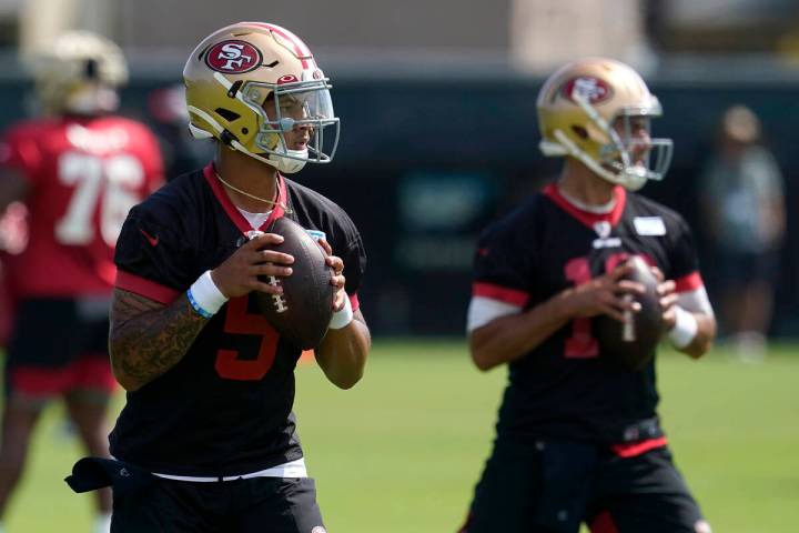 San Francisco 49ers quarterbacks Trey Lance, left, and Jimmy Garoppolo throw passes at NFL foot ...