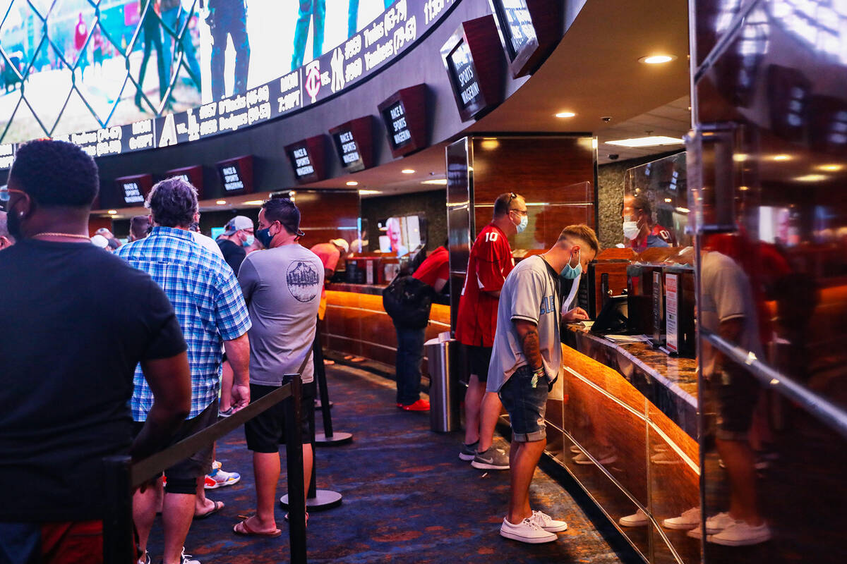 Guests place their bets at the Sports Book at Westgate in Las Vegas, Sunday, Sept. 12, 2021. (R ...