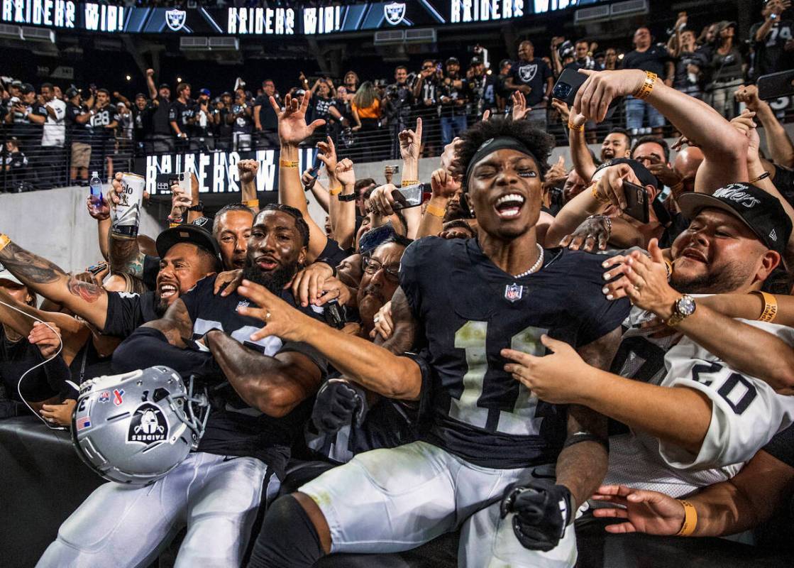 Raiders cornerback Nate Hobbs (39) and teammate Raiders wide receiver Henry Ruggs III (11) cele ...